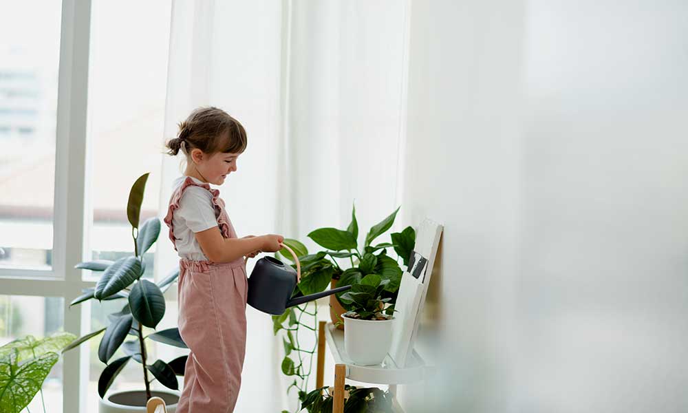 cute-little-girl-who-pours-plant-at-home